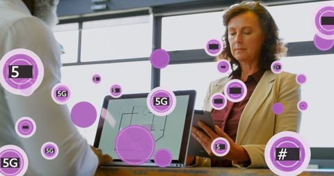 Diverse coworkers utilizing 5g technology in modern office