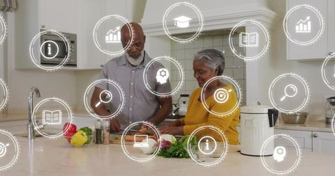 Chopping and prepping vegetables on modern kitchen island with digital wellness icons