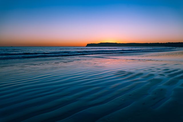 Serene Beach Sunset with Rippling Waves and Calm Waters - Download Free Stock Photos Pikwizard.com