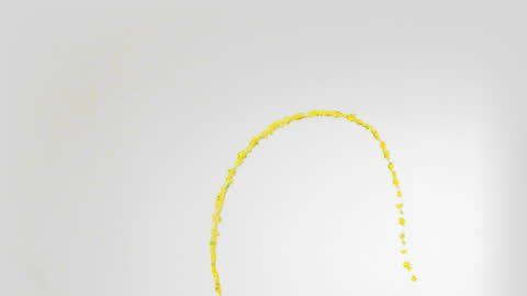 Yellow Paint Dripping in Slow Motion on Grey Background