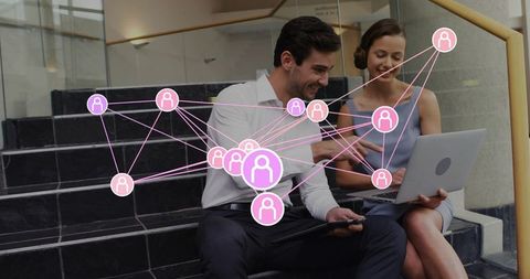Two colleagues collaborating on laptop and tablet with pink social network overlay