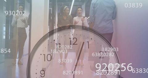 Colleagues walking in glass office corridor discussing project with clock and data overlay
