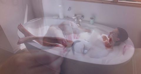 Woman Relaxing in Bubble Bath with Smartphone Her at Home