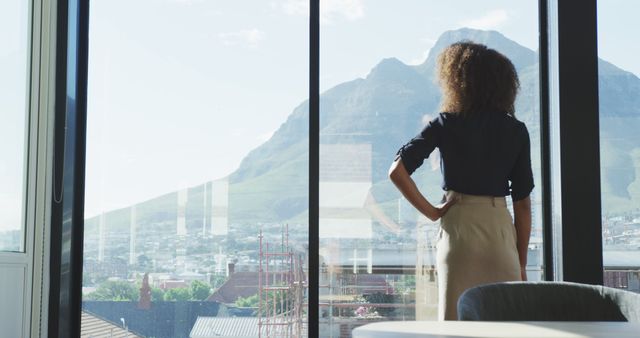 Businesswoman Looking Out Window at Mountain View - Download Free Stock Images Pikwizard.com