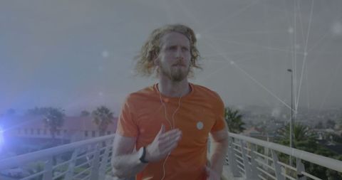 Young athlete jogging on urban bridge with fitness gadgets
