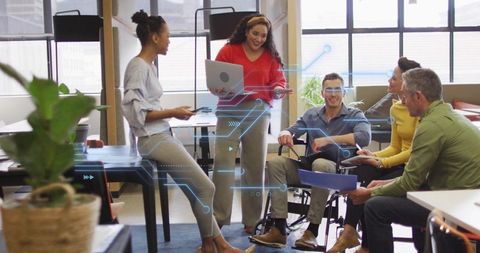 Startup team collaborating in modern office with futuristic digital circuit overlay