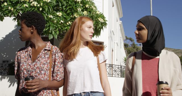 Diverse Young Women Walking Outside Holding Coffee Cups, Engaging Conversation - Download Free Stock Images Pikwizard.com