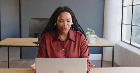 African American Woman Concentrating on Laptop Work at Office Desk - Download Free Stock Images Pikwizard.com
