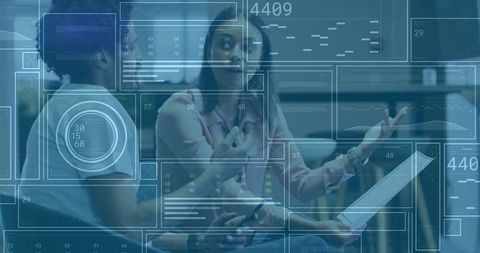 Business professionals analyzing digital data and charts in modern office