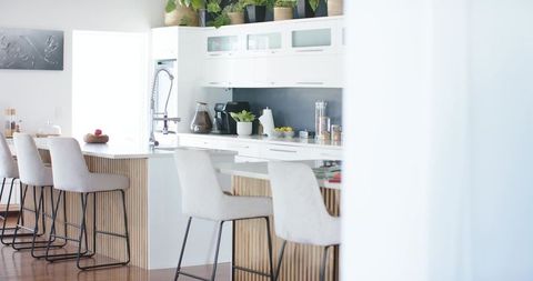 Bright Modern Kitchen Island with White Counter and Slatted Wood Bar Seating