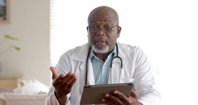 Senior Male Doctor Discussing with Tablet in Hand - Download Free Stock Images Pikwizard.com