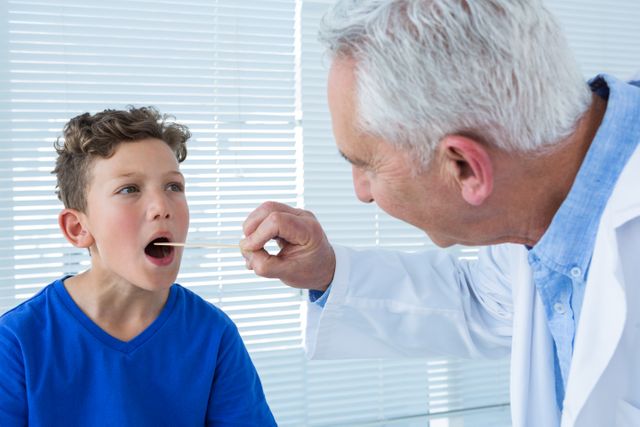 Doctor examining patients mouth in clinic