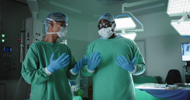 Two surgeons are preparing for surgery in an operating room, ensuring they follow sterilization protocols. This picture can be used for articles or materials related to surgery, teamwork in medical settings, hospital environments, healthcare practices, and professional collaboration among medical staff.