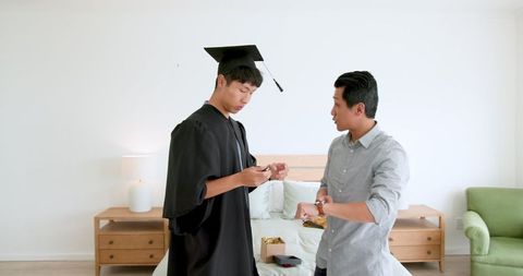 Graduate with Family Celebrating Proud Achievement in Bedroom