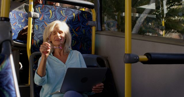 Smiling Senior Woman Using Laptop on Public Transport - Download Free Stock Images Pikwizard.com