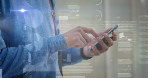 Businessman Interacting with Smartphone Amidst Financial Data Graphics