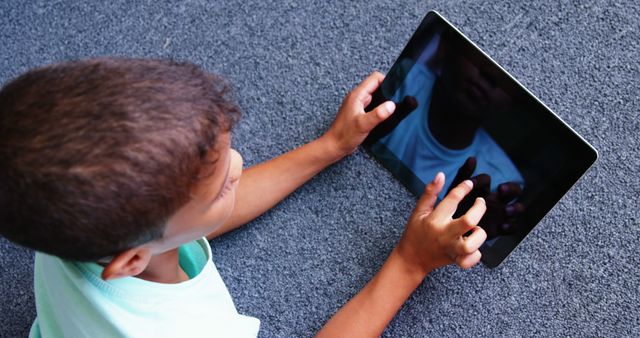 Child Engaging with Tablet Device on Carpet - Download Free Stock Images Pikwizard.com