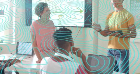 Professional presenting with tablet and teal topographic overlay during team meeting