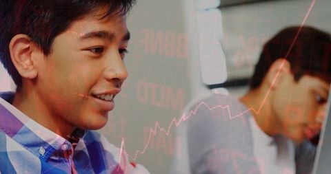 Teenage Boys Collaborating on Technology Project with Stock Market Chart Overlay