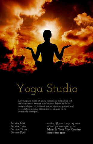 Silhouette practicing yoga in fiery sunset environments