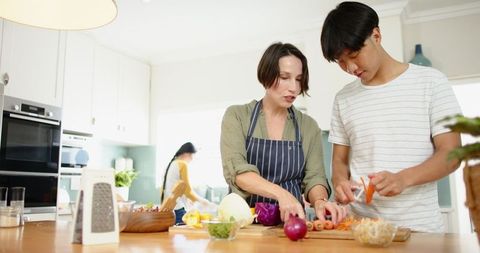 Diverse Family Cooking Together in Modern Kitchen