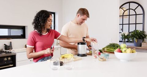 Couple Preparing Healthy Smoothie Together in Modern Kitchen