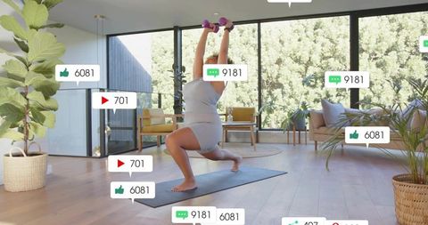 Woman lunging holding purple dumbbells in sunlit minimalist living room home workout