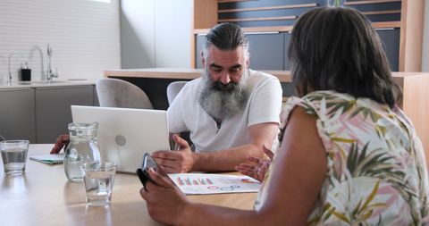Senior Couple Discussing Finances in Modern Kitchen Setting