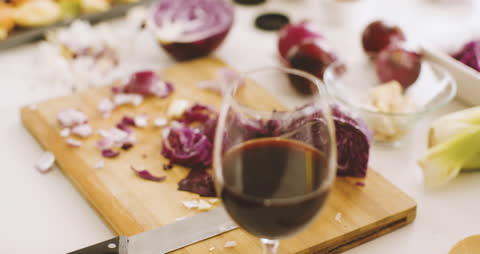 Cozy Kitchen Scene with Vegetables and Red Wine