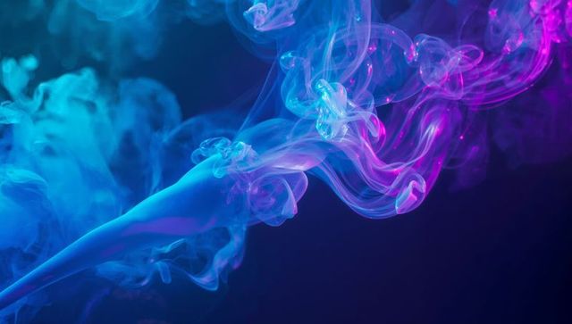 Vibrant Neon Smoke Swirling Across Dark Background