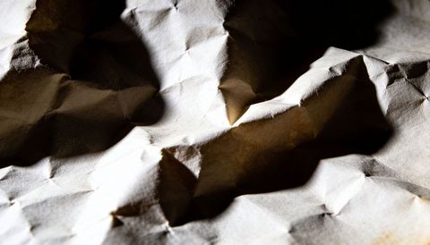 Revealing Crumpled Kraft Paper Texture with Dramatic Light and Deep Creases