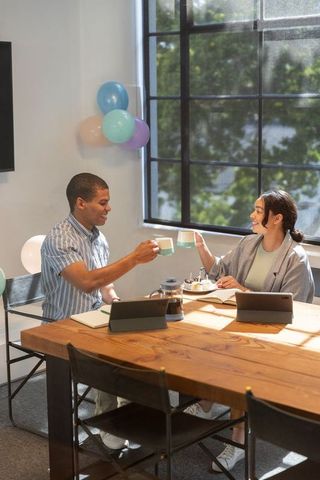 Diverse Coworkers Enjoying Coffee Break in Modern Office with Balloons