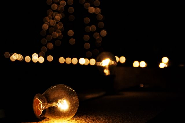 Warm Glowing Light Bulbs Against Dark Background with Bokeh - Download Free Stock Photos Pikwizard.com