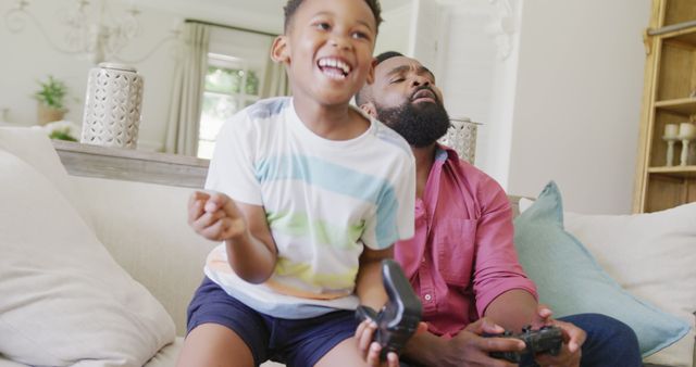 Father and Son Enjoying Video Game Together in Living Room - Download Free Stock Images Pikwizard.com