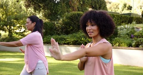 Mother and Daughter Practicing Tai Chi Outdoors in Park