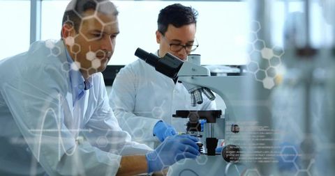 Scientists preparing samples and analyzing under microscope in modern biotech laboratory