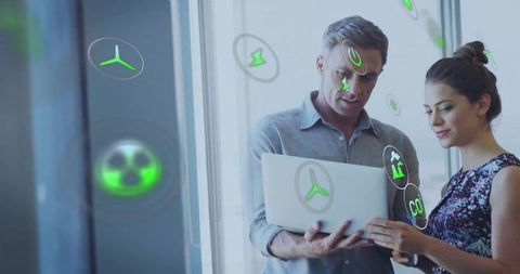 Innovation Team Analyzing LED-Screen Infographics on Laptop