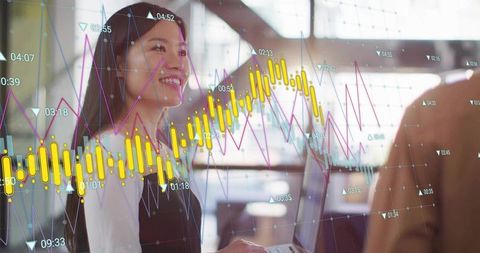 Asian businesswoman analyzing stock data on laptop in modern office