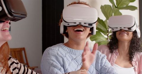 Women enjoying virtual reality experience at home