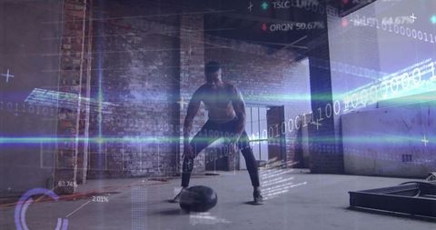 Shirtless athlete slamming medicine ball in industrial warehouse with digital hud overlays