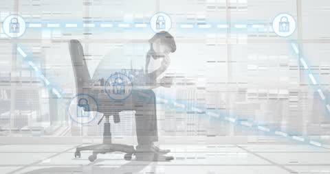 Stressed Businessman Surrounded by Digital Security Icons in Office