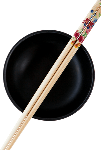 image features artistic chopsticks resting on black bowl, evoking themes of culinary elegance and minimalistic style. ideal for use in cooking blogs, restaurant marketing materials, or instructional content related to asian cuisine.