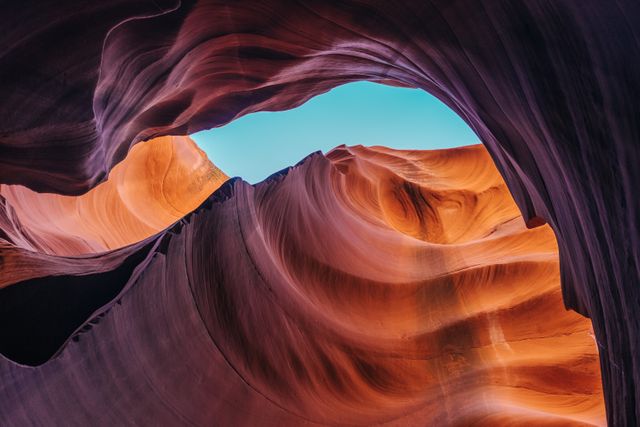 View of stunning rock formation and sky in Antelope Canyon, showcasing vibrant sandstone colors. Perfect for use in travel promotions, nature and adventure blogs, geological studies, and educational materials.