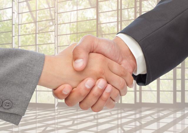 Digital composition of businessman and woman shaking hands