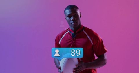 Athlete Holding Football with Social Icon in Vibrant Studio