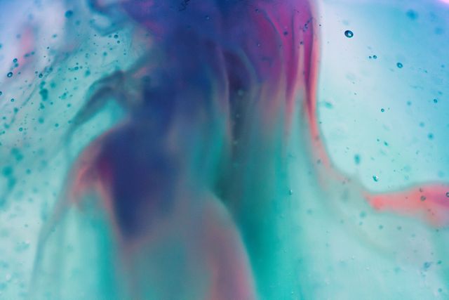 Abstract image depicting colorful ink swirling in water creating a dreamy effect. Ideal for using as a background in art projects, website design, social media posts, or digital illustrations.