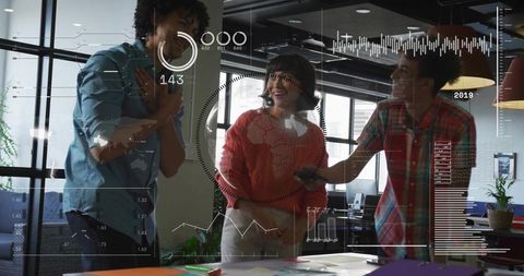 Diverse team collaborating around interactive data HUD and charts in modern office workspace