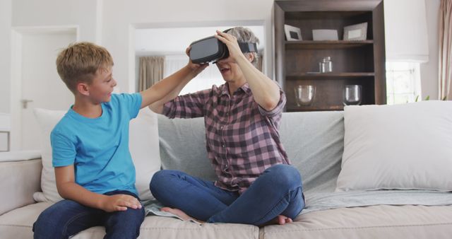Happy Grandmother and Grandson Using Virtual Reality Headset On Couch - Download Free Stock Images Pikwizard.com
