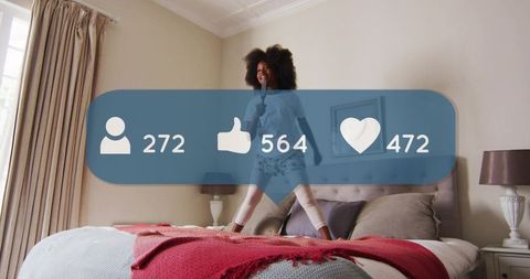 Playful girl jumping on bed singing into microphone with social media likes overlay