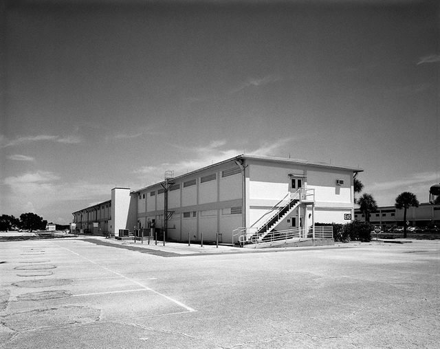 Exterior view of large industrial building on clear day